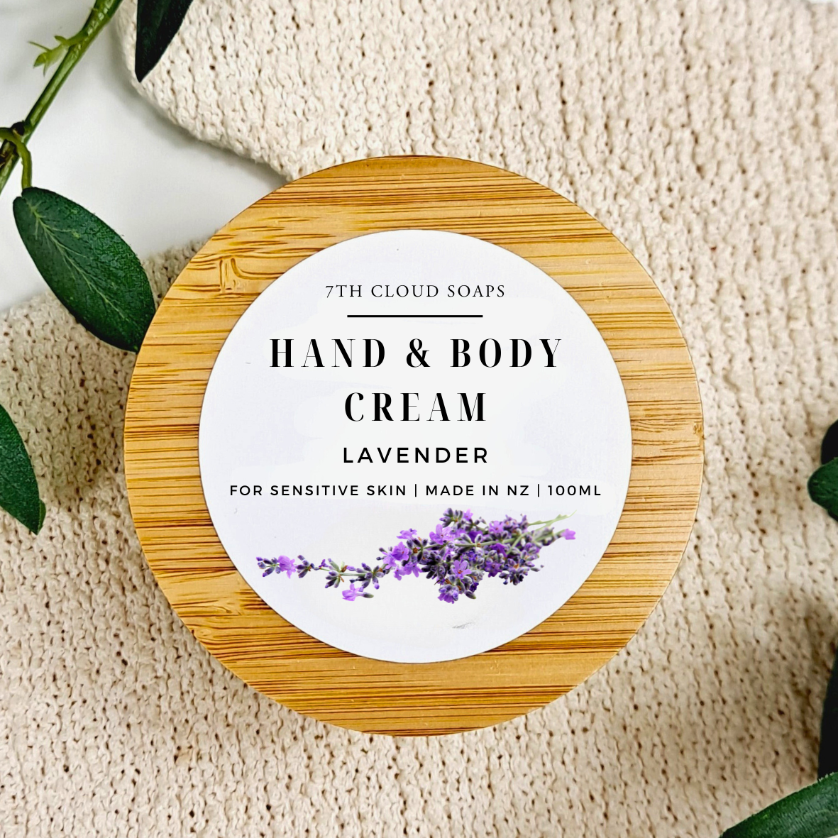 Hand and body cream container with lavender design on a textured surface