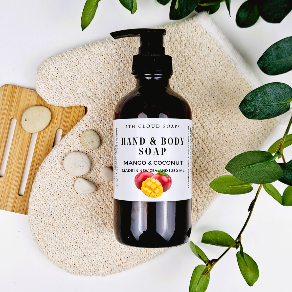 A 250ml glass bottle of liquid hand & body soap labeled 'Mango & Coconut', with a pump dispenser.