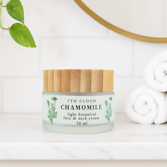 Jar of 7th Cloud Chamomile light botanical face & neck cream with a wooden lid on a white surface.