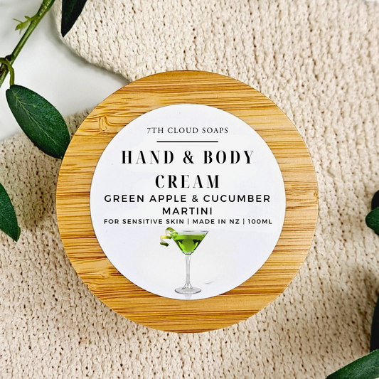 Hand and body cream container with a wooden lid on a textured surface.