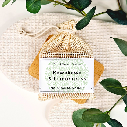 Kawakawa & Lemongrass natural soap bar in a mesh bag with green leaves on a light background